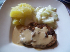 Chops with sauce boiled potatoes and vegetableskohlrabi