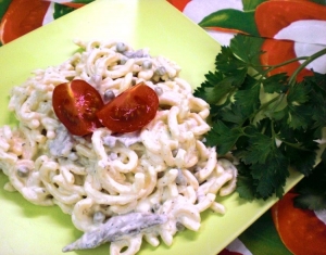 Forkful of spaghetti salad with peas mushrooms and horseradish dressing