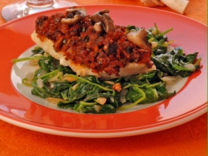 Fish fillet with mushroom crust on spinach