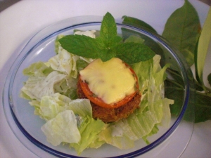 Hack muffins with tomato and cheese on a bed of lettuce