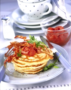 Hearty pancakes with crispy bacon tomato spread and arugula
