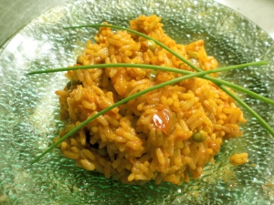 Orange rice with tomatoes and peas