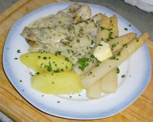 Pollock fillet with herb sauce and buttered asparagus