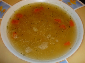 Clear chicken soup with noodles or rice