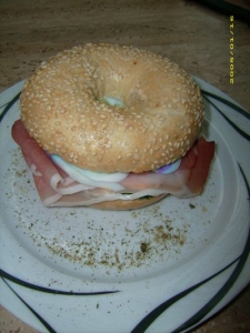 Bagel with cream cheese black forest ham egg and spring onions