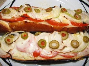 Baked Pretzel stick with feta olives tomatoes and onions