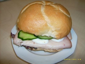 Kaiser roll with turkey breast egg cucumber and lettuce