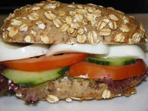 Oatmeal bread with cream cheese tomato cucumber and egg